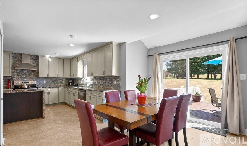 A dining room with a table and chairs is shown.