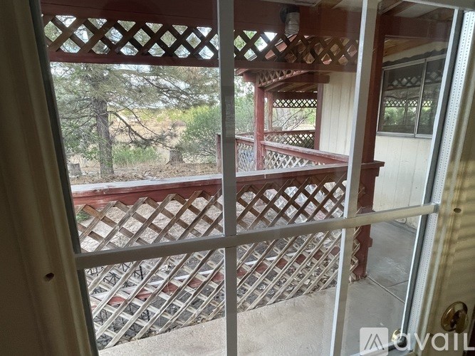 A view from inside a house looking out to a deck.