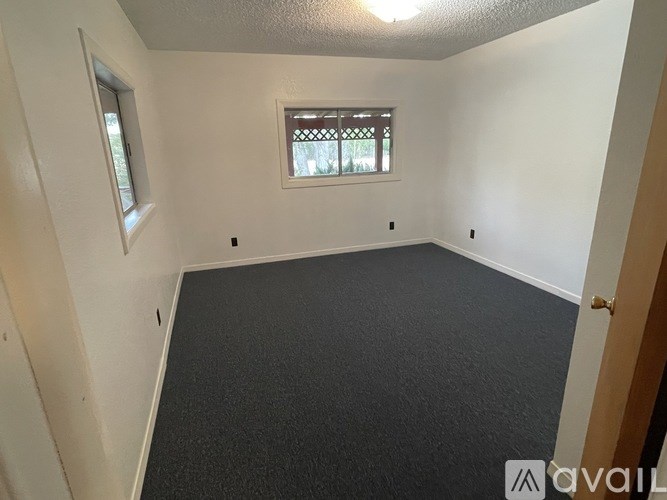 A room with a window and a door.