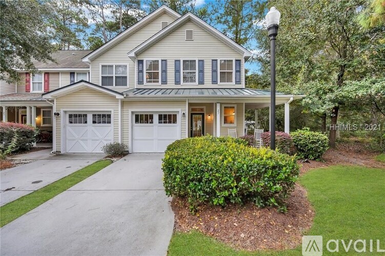 A house with a garage and a driveway is for sale.