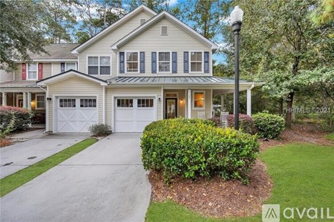 A house with a garage and a driveway is for sale.