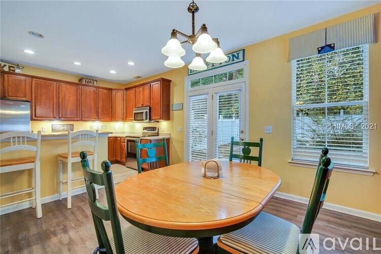 A dining room with a wooden table and chairs.