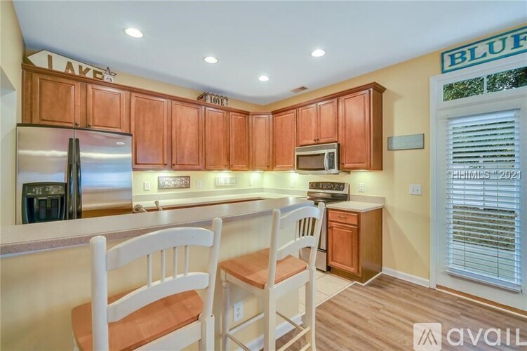 A kitchen with wooden cabinets and a white countertop.