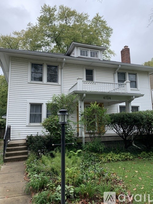 A white house with the number 4734 on the front porch.