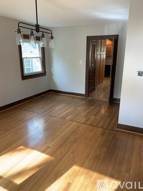 A room with wooden floors and a window.
