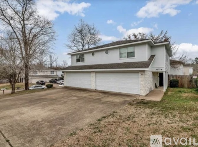 A two-story house with a garage is available for rent.