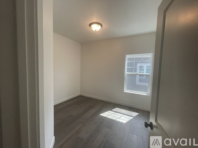 A room with a window and a light on the ceiling.