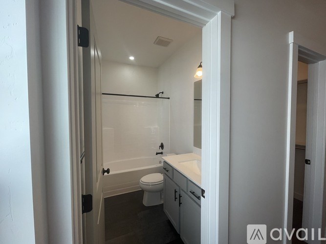 A bathroom with a toilet, sink, and bathtub.