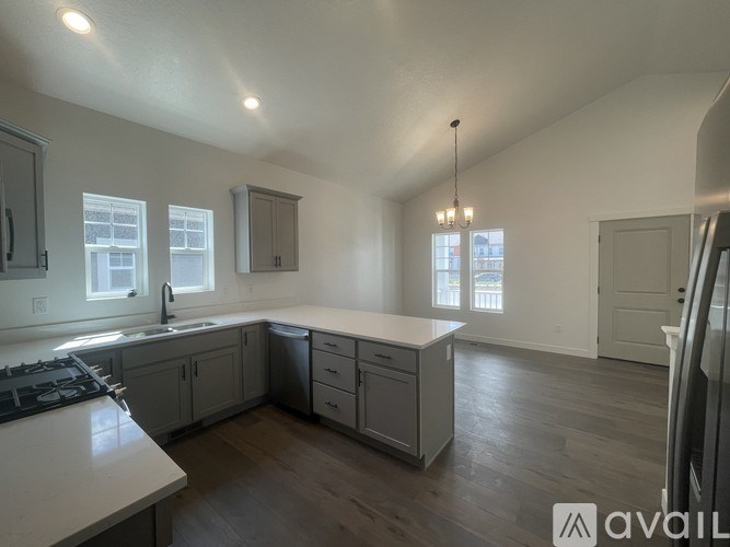 A kitchen with a stove top oven and a sink.