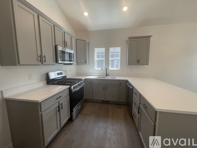 A kitchen with wooden floors and white countertops.