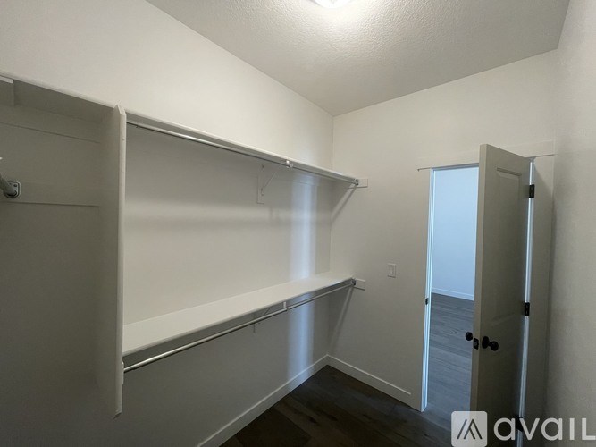 A room with a door and a shelf.