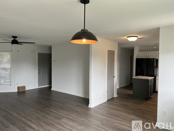 A room with a ceiling fan and a light hanging from the ceiling.