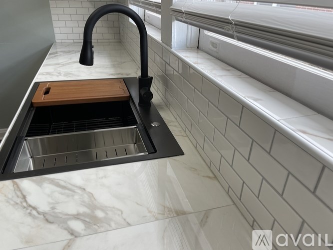 A kitchen sink with a wooden drain cover.