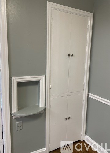 A white door with a small window in the middle.