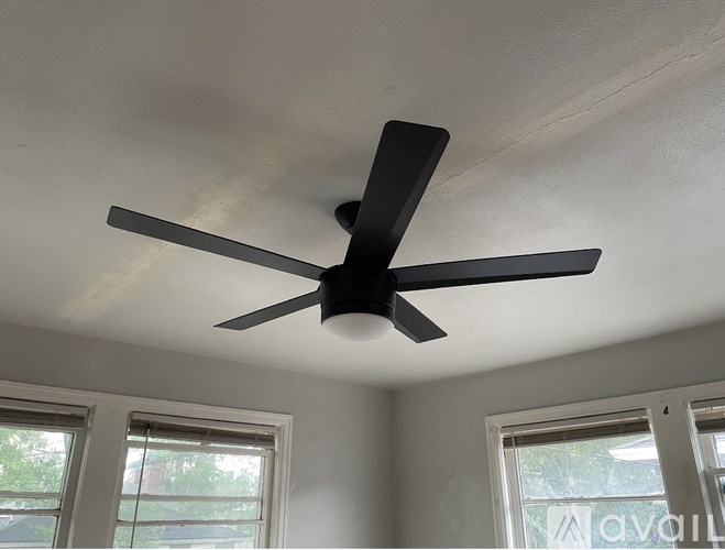 A ceiling fan is mounted on a white ceiling.
