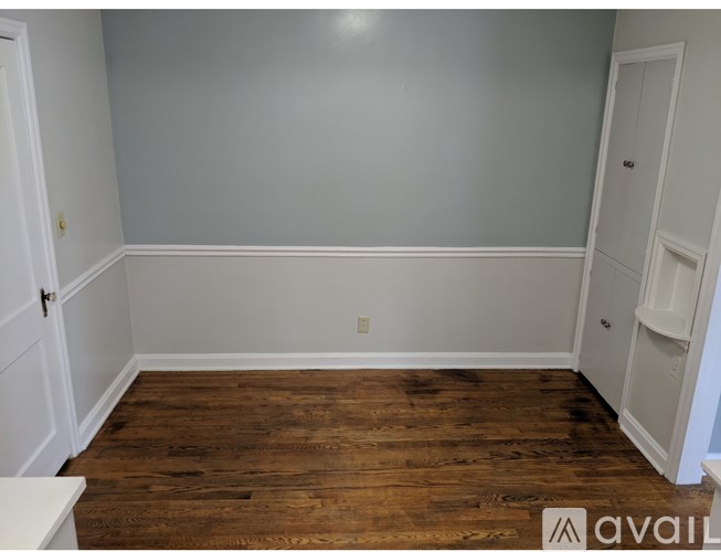 A room with wooden floors and white walls.