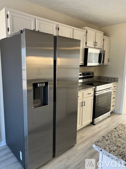 A modern kitchen with a stainless steel refrigerator.