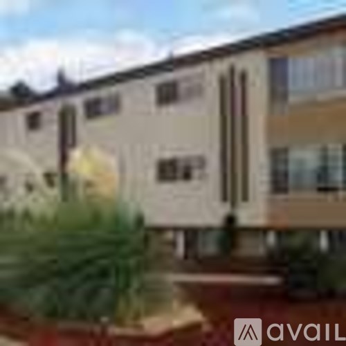 A building with a tree in front of it.