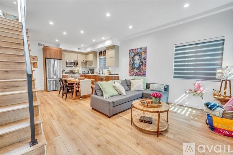 A living room with a grey couch and a coffee table in the middle.