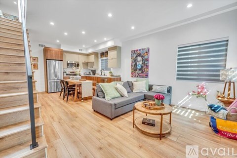 A living room with a grey couch and a coffee table in the middle.