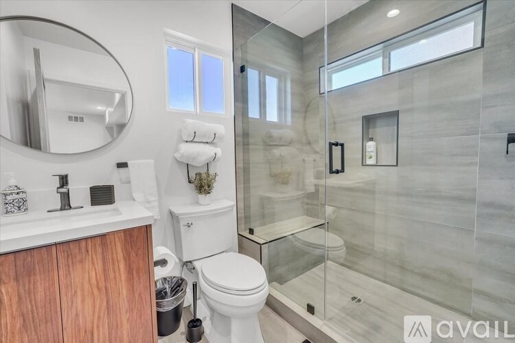 A bathroom with a toilet, sink, and shower.