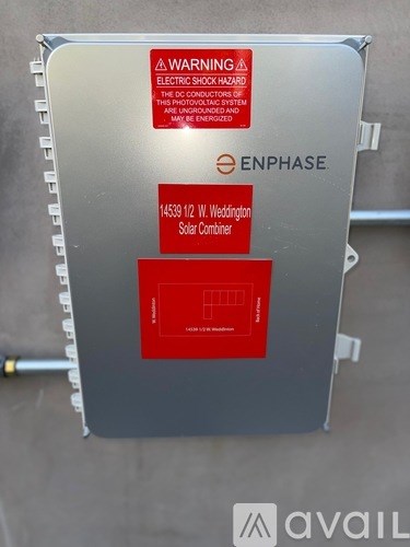 A solar combiner box from Enphase is labeled with a warning for electric shock hazard.