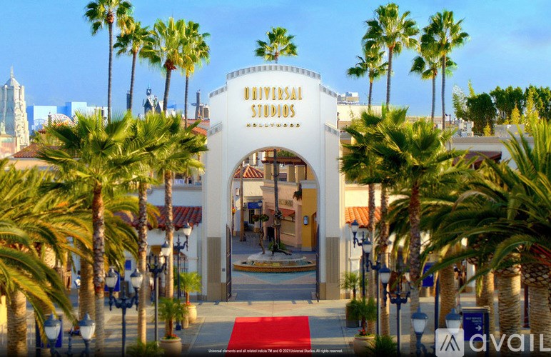 Universal Studios entrance with palm trees on either side.