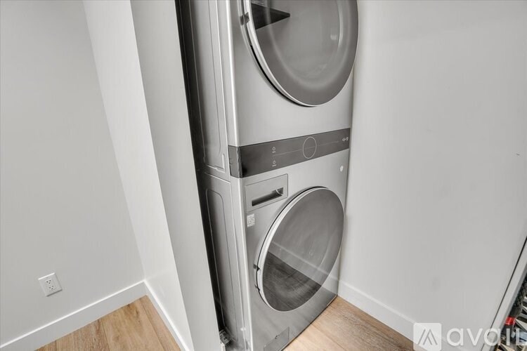 A modern front-loading washing machine in a laundry room.