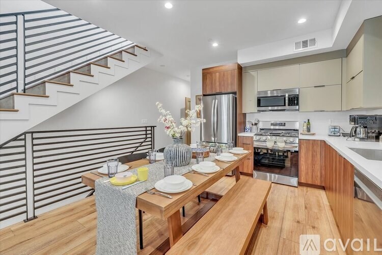 A modern kitchen with a dining table and chairs is available for rent.