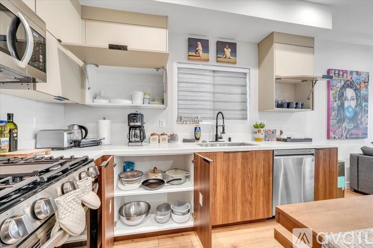A modern kitchen with wooden cabinets and stainless steel appliances.