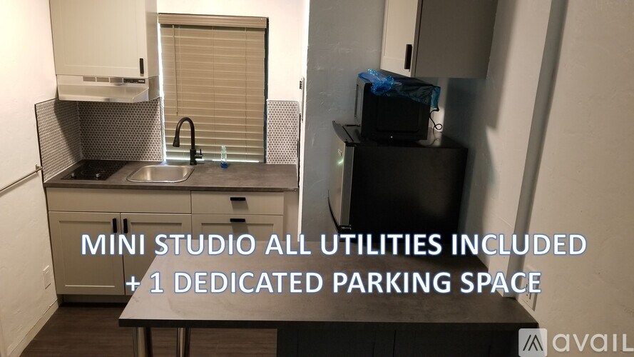 A small studio apartment with a kitchen and a dedicated parking space.
