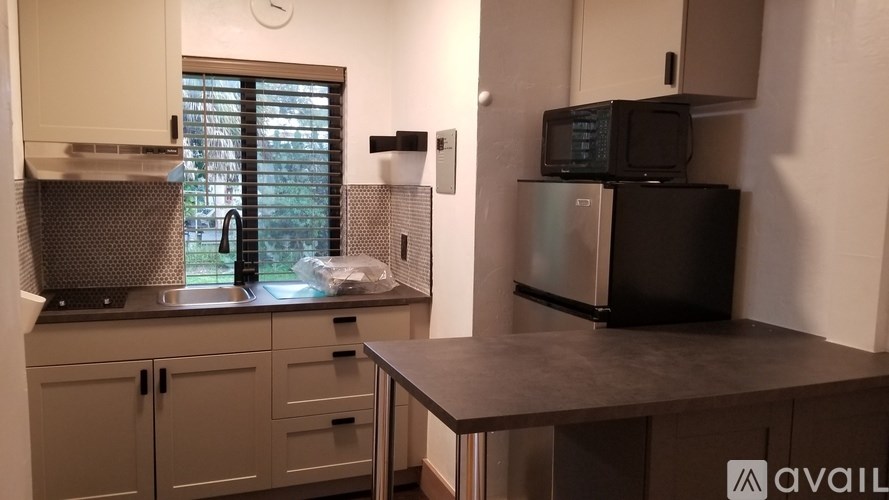 A kitchen with a microwave and oven on a counter.