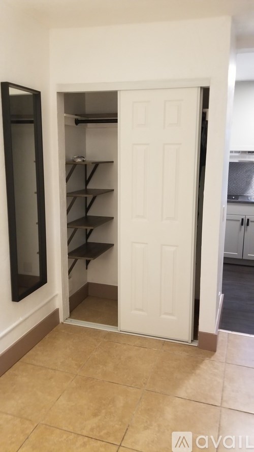 A white door with shelves inside it.
