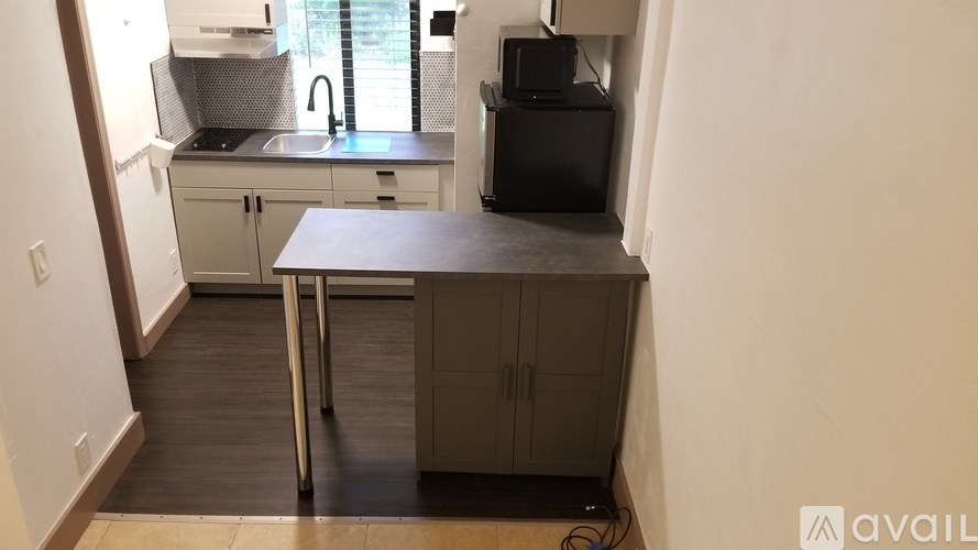 A kitchen area with a sink, a microwave, and a dishwasher.