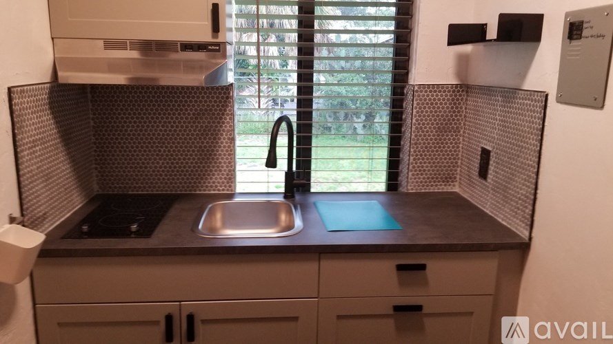 A kitchen with a sink and a window.