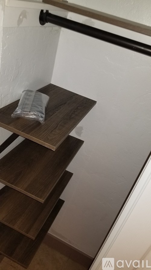 A wooden staircase with a plastic bag on the top step.