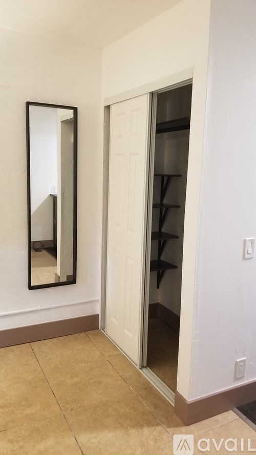 A white door with a mirror above it.