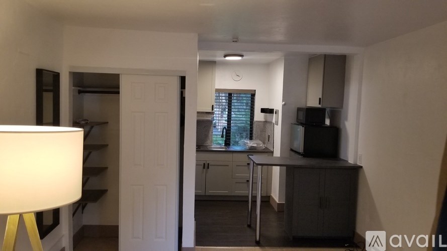 A room with a desk, a chair, and a lamp.