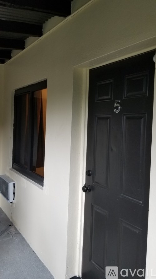 A black door with a number 5 on it.