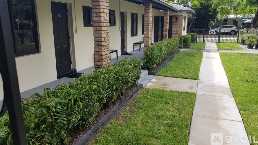 A row of houses with green bushes in front.