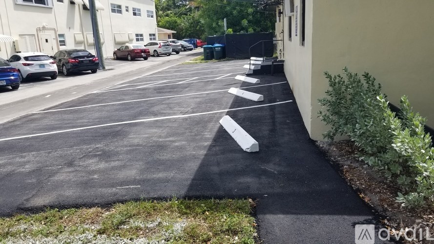 A parking lot with cars parked and a white line painted on the ground.