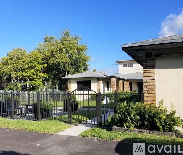 A house with a black fence and a sign that says "available" in front of it.