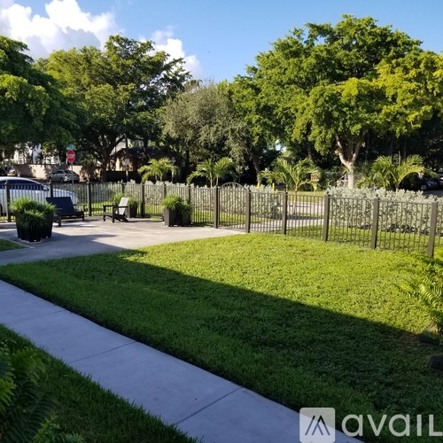 A park with a fence and a bench.