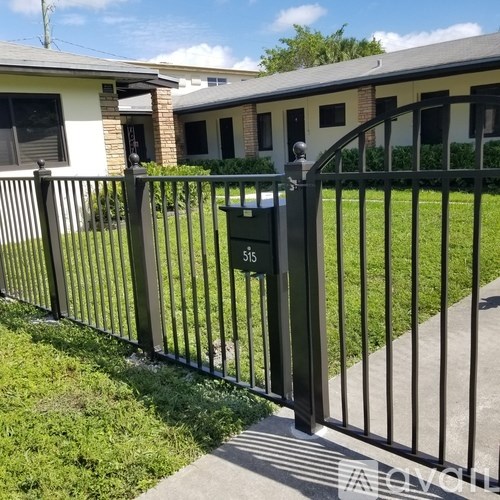 A black metal fence with a mailbox on it.