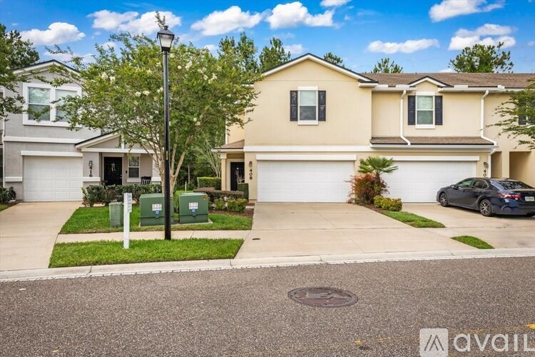 A house with a car parked in front of it.