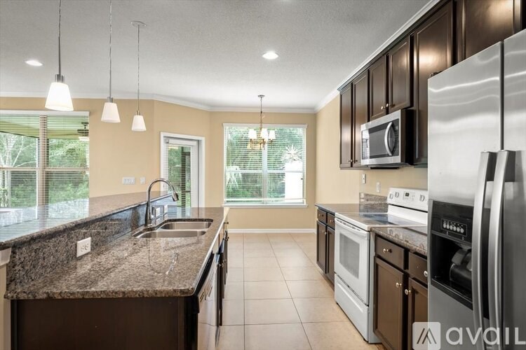 A kitchen with granite countertops and stainless steel appliances.