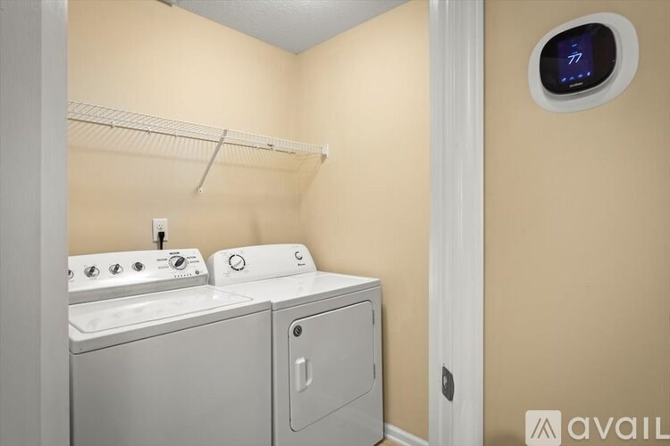 A small laundry room with a washer and dryer.