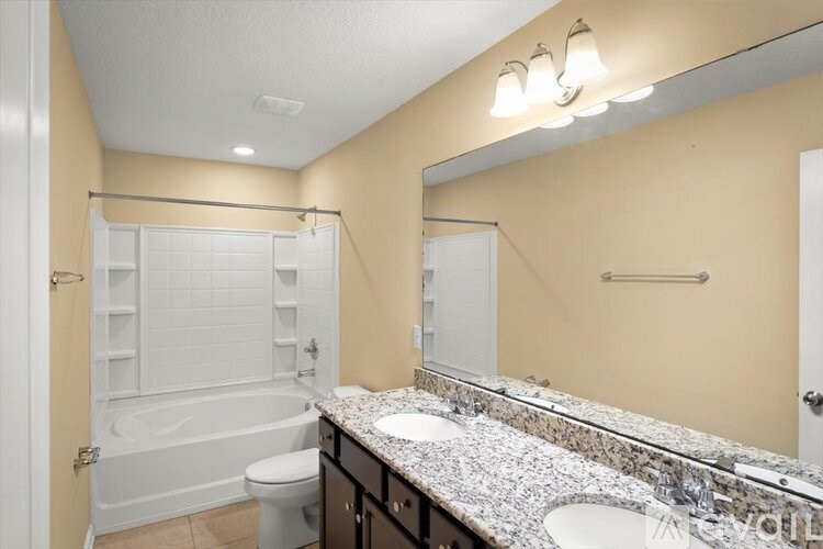 A bathroom with a marble countertop and a white toilet.