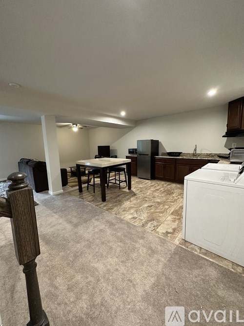 A kitchen area with a dining table and chairs.