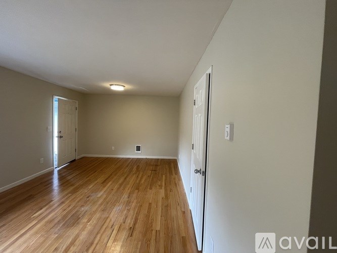 A room with wooden floors and white walls.